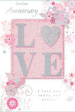 This anniversary card captures the tenderness of long-lasting romance, as if it were a bouquet delivered from a trusted Kings Cross florist on a special evening. In the centre, the word LOVE rises in softly curved, raised letters, each one dusted with a fine layer of pale glitter that shimmers with movement, yet remains gentle on the eye. The letter O is transformed into a gleaming heart, textured in silver with an almost metallic sheen that stands out while staying perfectly in tune with the rest of the design. Around this focal point, delicate blossoms in shades of blush, rose, and muted mauve unfold with a watercolour softness, their edges slightly blurred so they blend naturally into the pale pink backdrop. Flowing lines of foliage and swirling flourishes weave around the blooms, echoing the organic curves of stems and vines expertly arranged in a romantic bouquet destined for a Kings Cross doorstep. Here and there, tiny petals, graceful loops, and discreet butterfly shapes add a gentle sense of motion, like a breeze winding through an English spring garden tucked behind a row of townhouses near Regent's Canal. At the top and bottom of the card, phrases such as On Our Anniversary and I love you today and always are written in a fine, understated script that supports the design without overpowering it. The palette of pastel pinks and silvery greys, together with the layers of embossing and glitter, creates an atmosphere of treasured intimacy, turning this card into a keepsake that speaks quietly yet deeply of shared memories and continued devotion in the heart of Kings Cross.